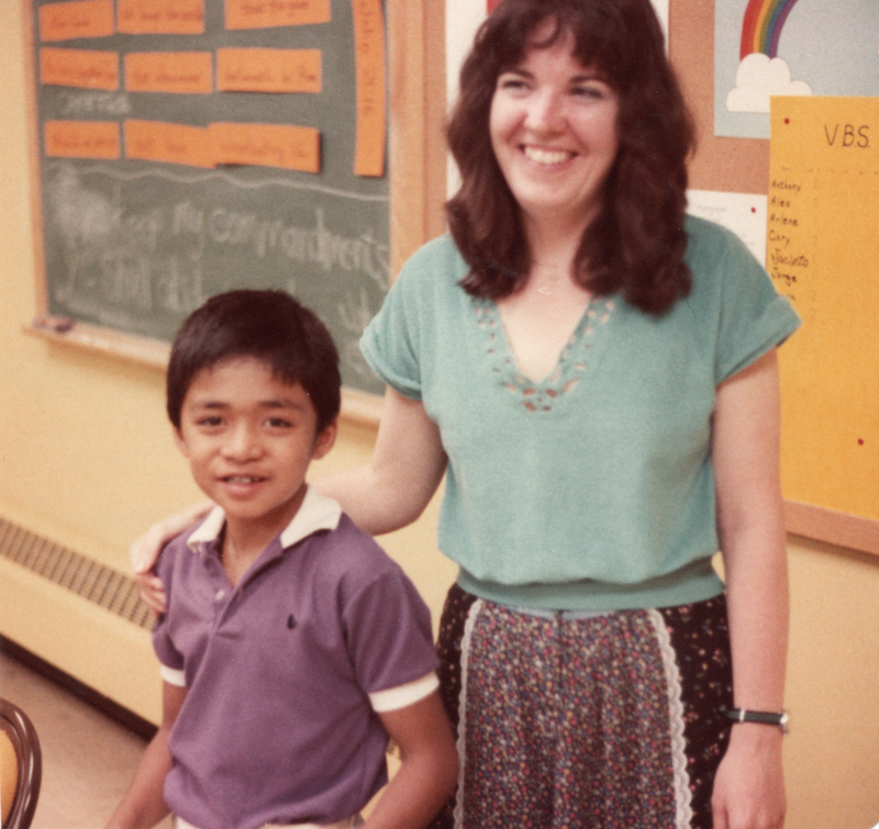 A boy and woman smile together for a portrait