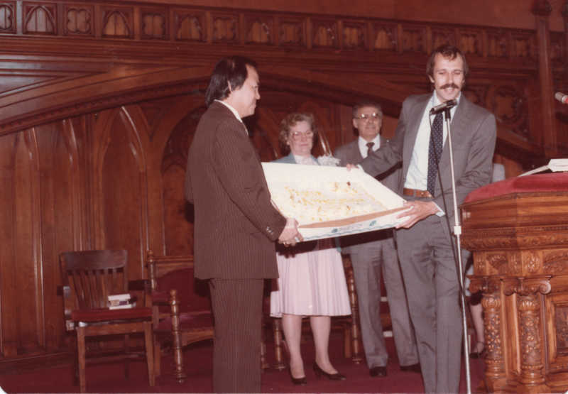 Pastor and Mrs. Bogdan are presented a large cake in the sanctuary