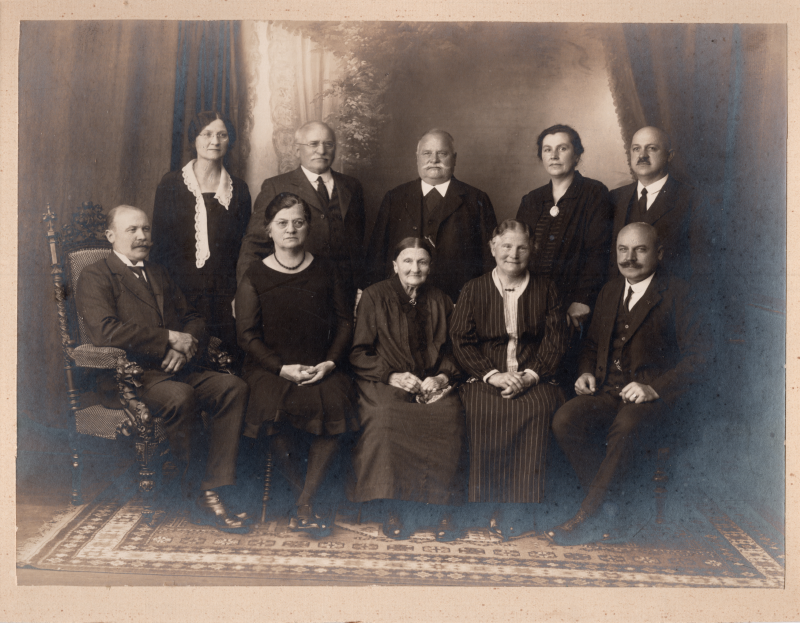 A group of older men and women pose together for a portrait