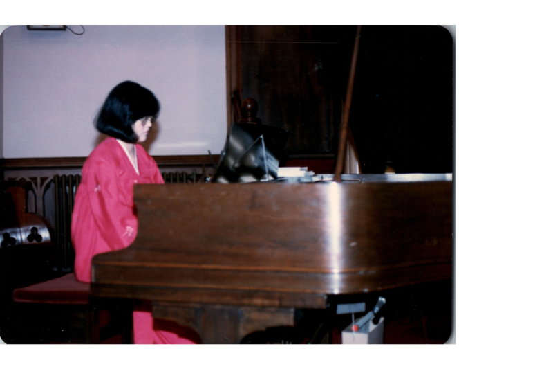 A woman in traditional Korean clothing plays piano in the sanctuary