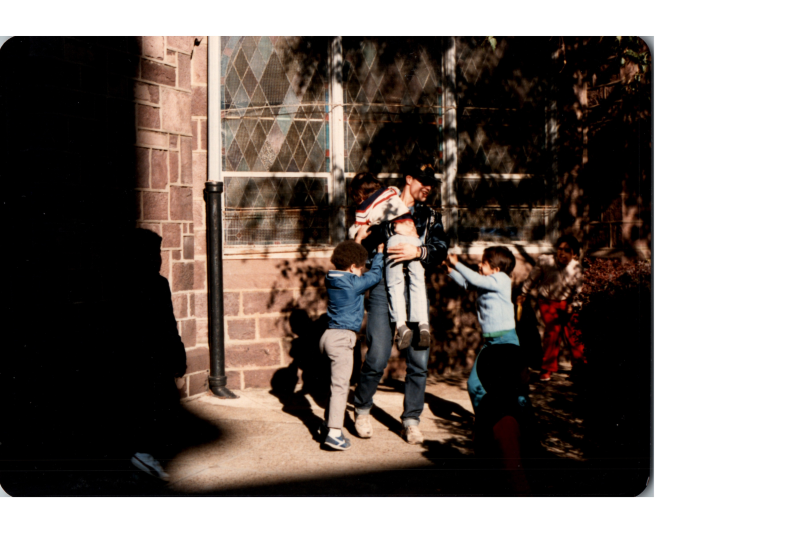 A group plays together outside of the building at 18th and Spring Garden Streets