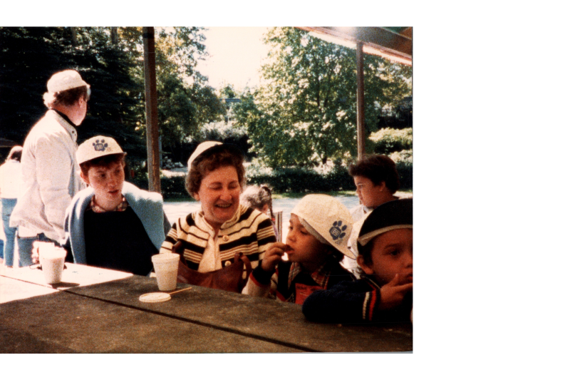 A group eats together at a picnic table