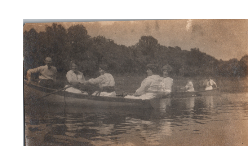 A group of men and women rowing on water