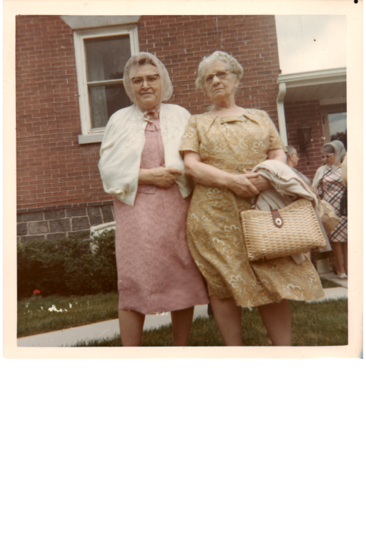 Two women pose for a portrait