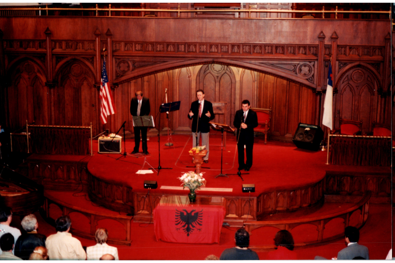 Music performance in front of an Albanian flag in the sanctuary