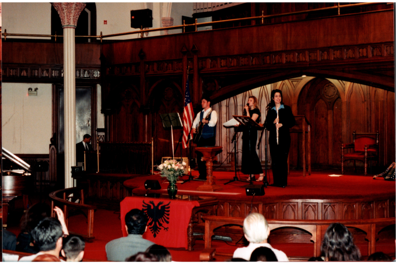Music performance in front of an Albanian flag in the sanctuary