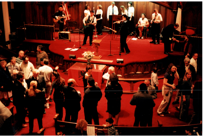 Music performance in front of an Albanian flag in the sanctuary