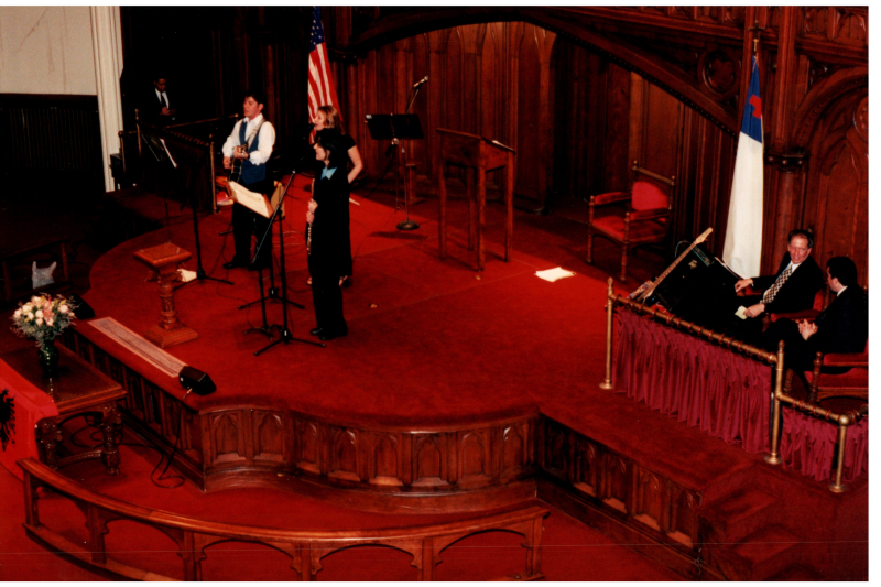 Music performance in front of an Albanian flag in the sanctuary
