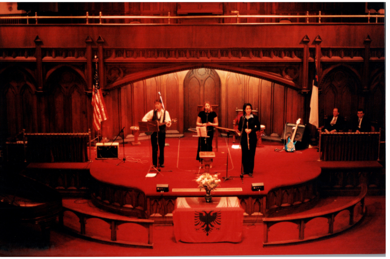 Music performance in front of an Albanian flag in the sanctuary