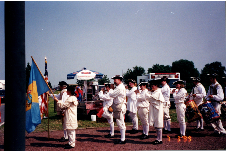 A historical reenactment next to a yellow school bus