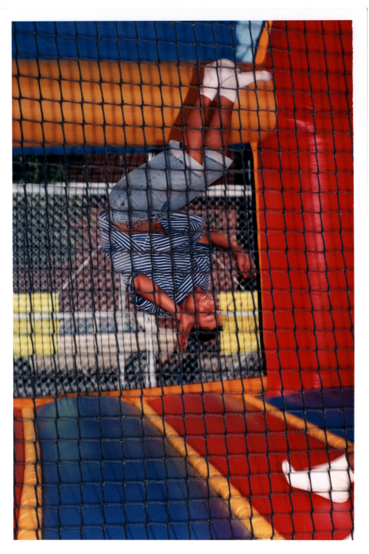 A boy flips in a trampoline