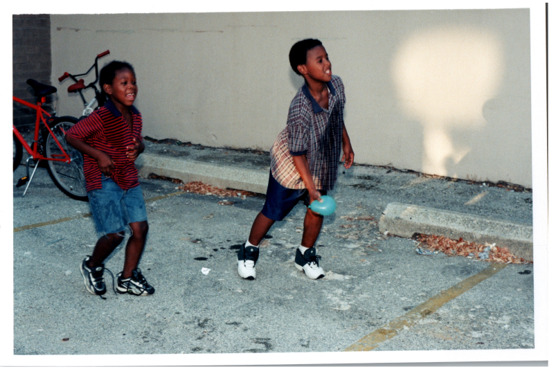 Boys throw water balloons