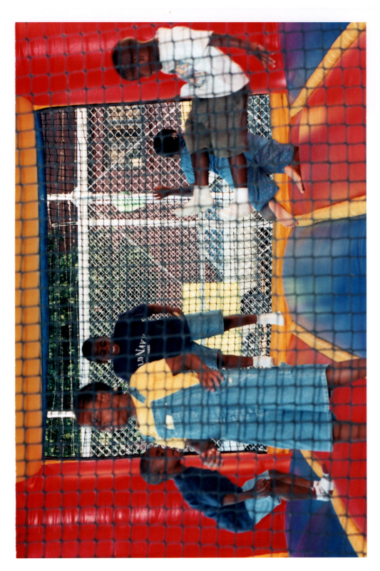 Children play in a bouncy house