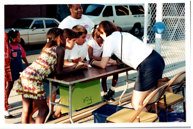 Children gather at a table