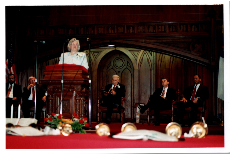 Mrs. Bogdan speaks with Pastor Bogdan, Pastor Wegner, Otis A. Fortenberry, and two other men sitting behind her