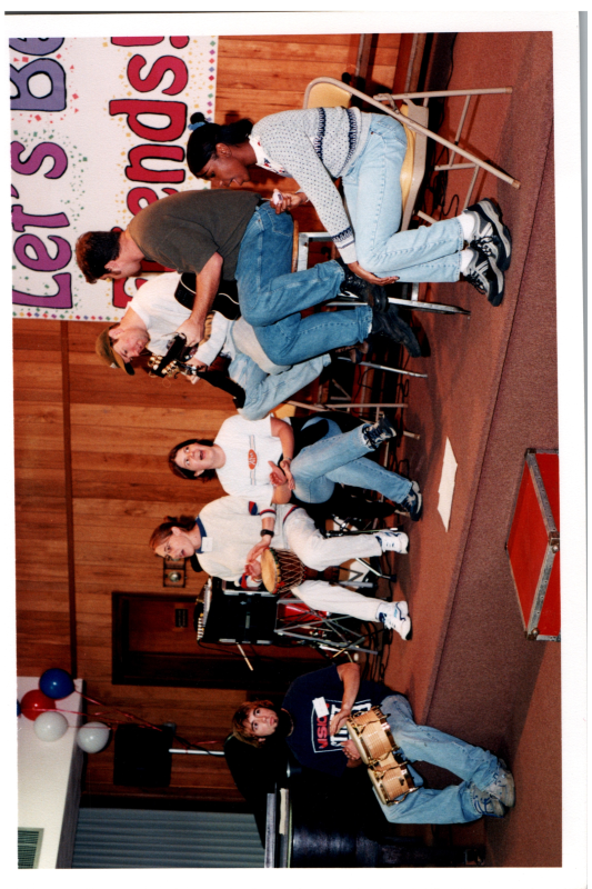 A group sings and playes instruments together