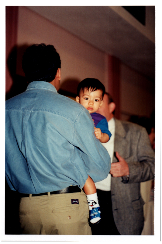 Baby held by a man