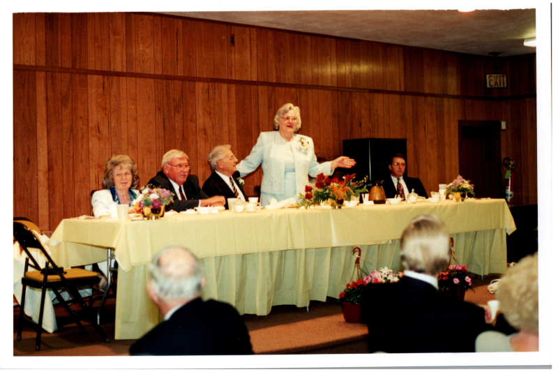 Mrs. Bogdan speaks from a front table
