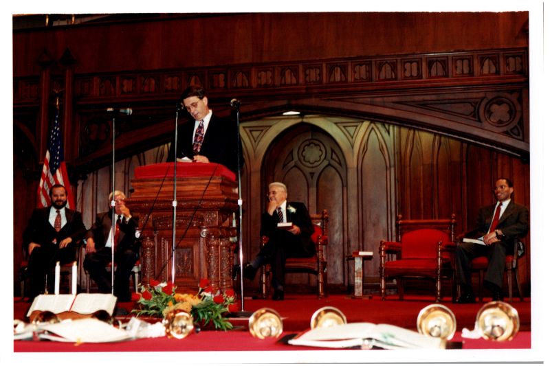 A woman speaks in the sanctuary