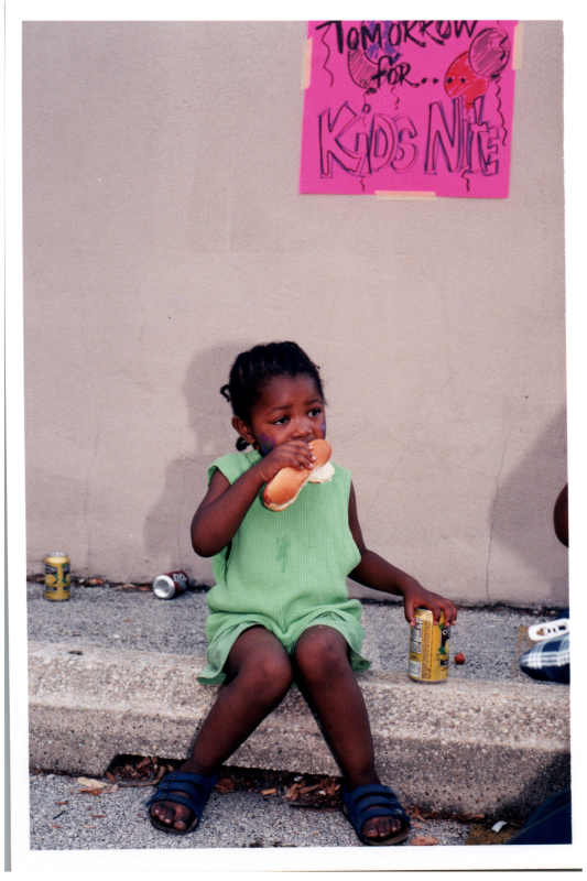 A girl eats a hotdog