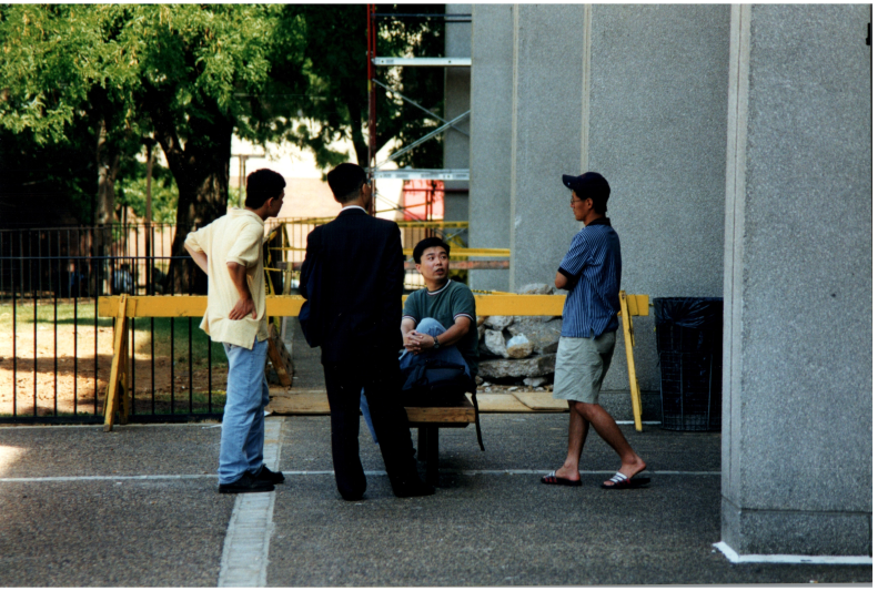 Men speak together outside