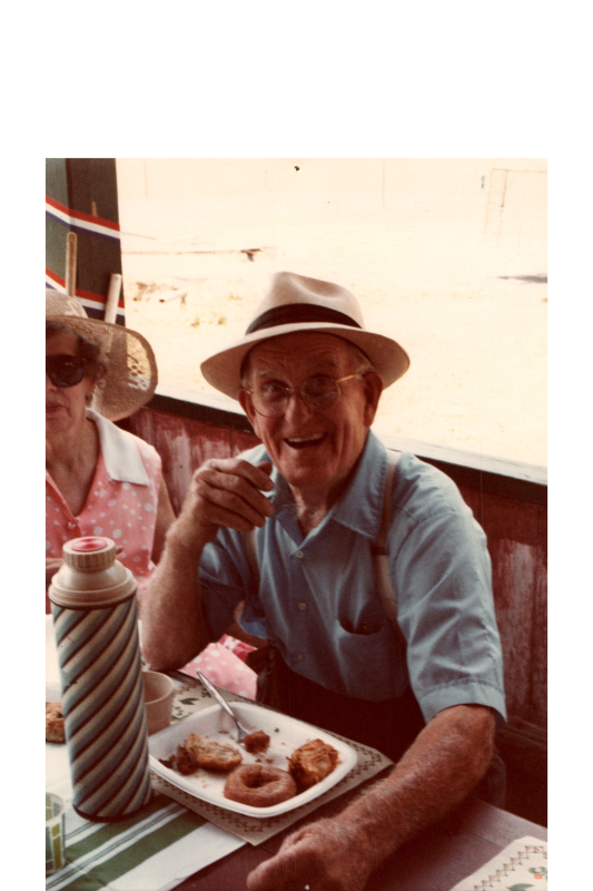 A man smiles with a plate of food