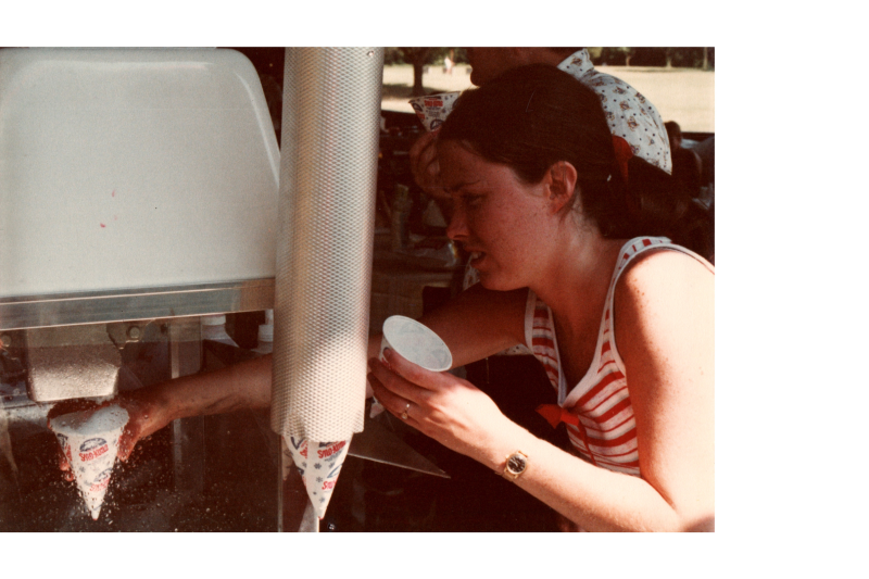 A woman serves snow-cones