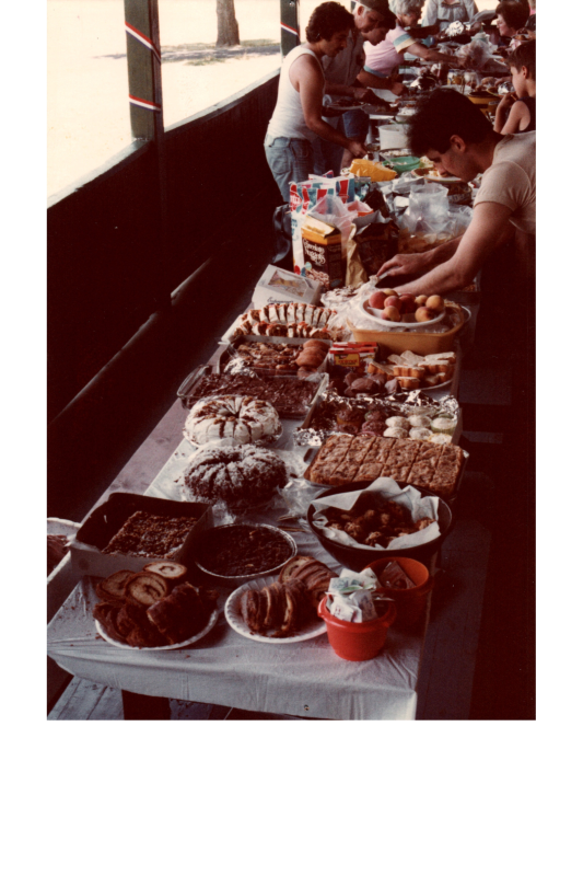 People serve themselves from a spread of food