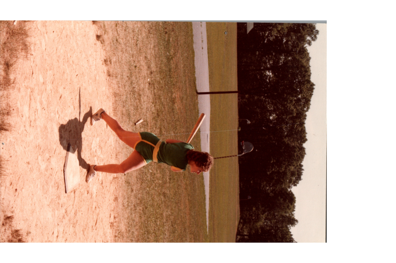 A woman swings a baseball bat