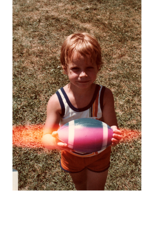 A child holds a football