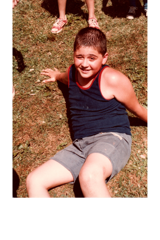 A boy sits on the ground