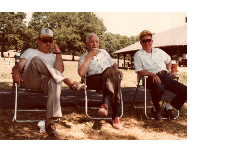 Three men sit together