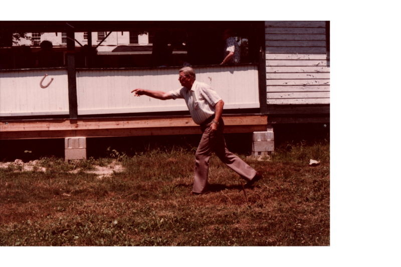 A man throws a horseshoe