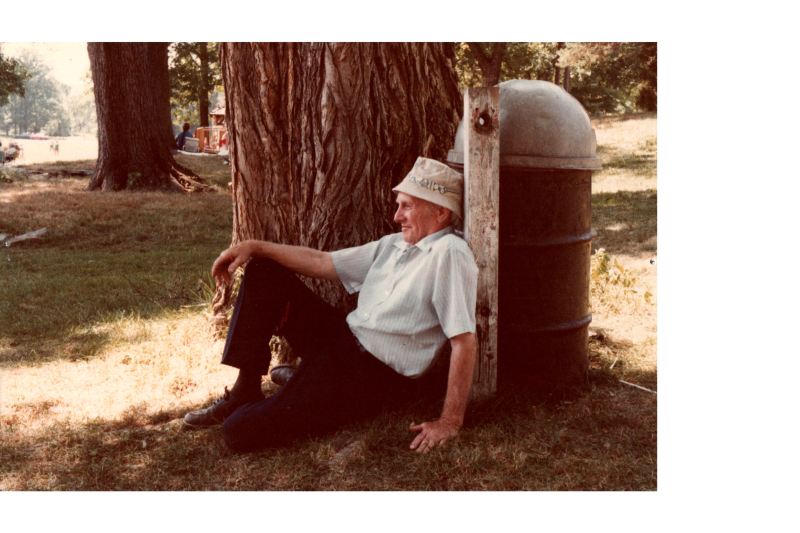 A man sits under a tree
