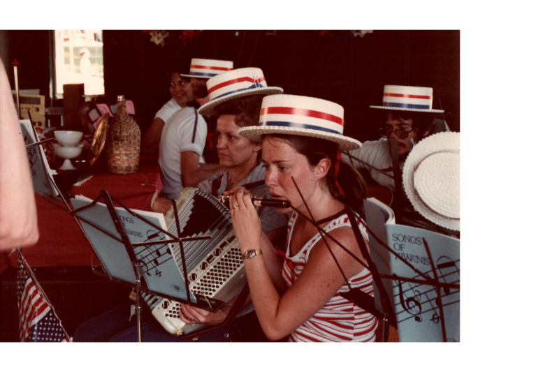 A woman plays a flute