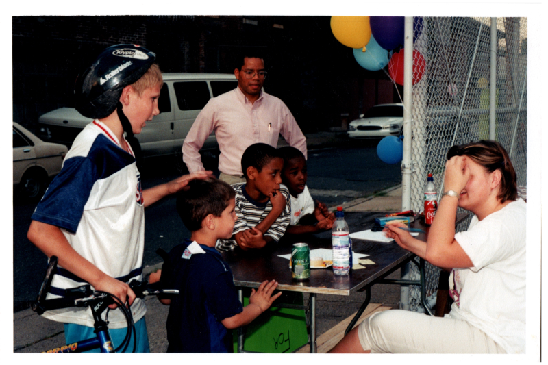 Children speak to a woman, Otis A. Fortenberry in the background