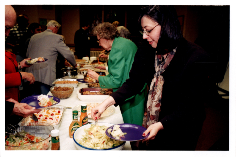 Candace Wegner and others eat from a buffett