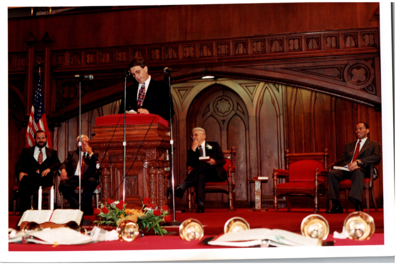 Pastor Wegner speaks with Pastor Bogdan, Otis A. Fortenberry, and two other men in the background