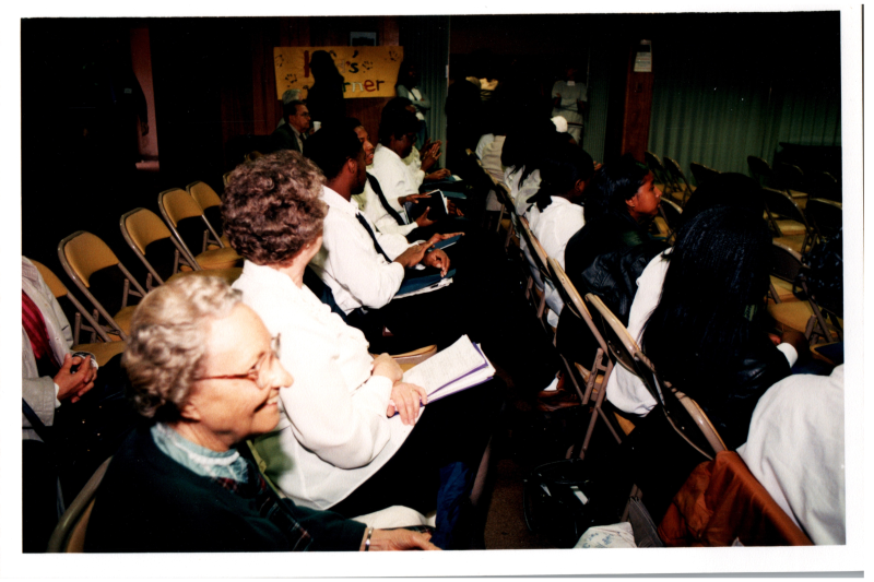 Congregants sit facing the stage