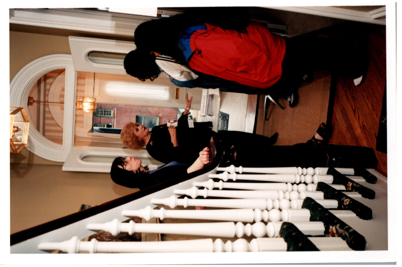 A group, including Candace Wegner and Cizely Kurian, stand in the foyer of the parsonnage
