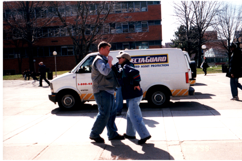 Group talks in front of a Specta-Guard van