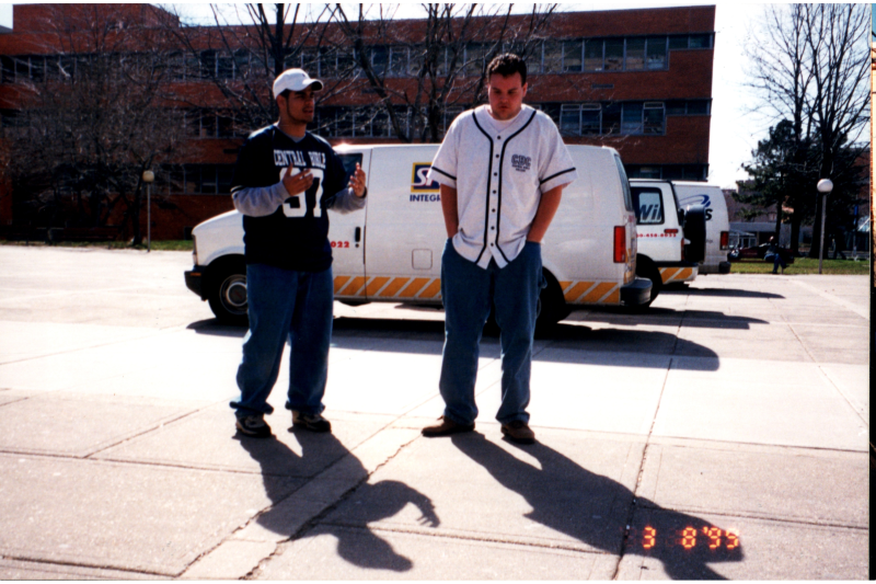 Group talks in front of a Specta-Guard van