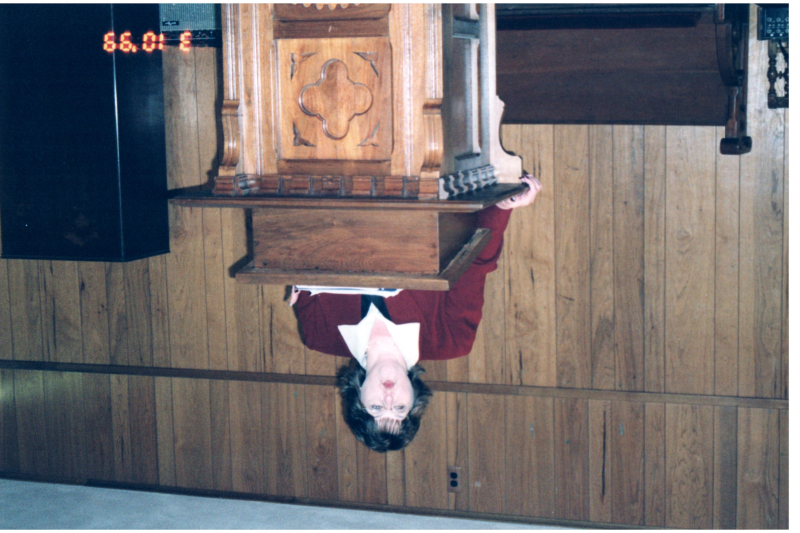 A woman speaks from the pulpit