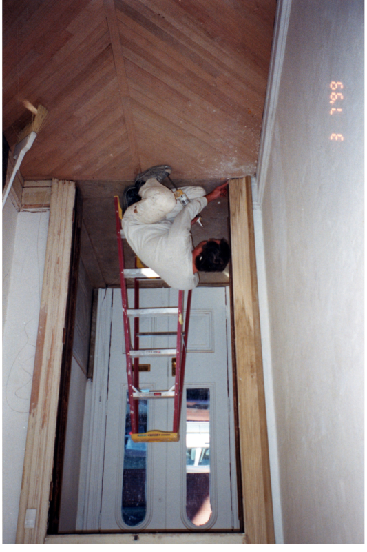A man caulks a doorway