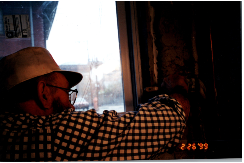 A man helps place windows