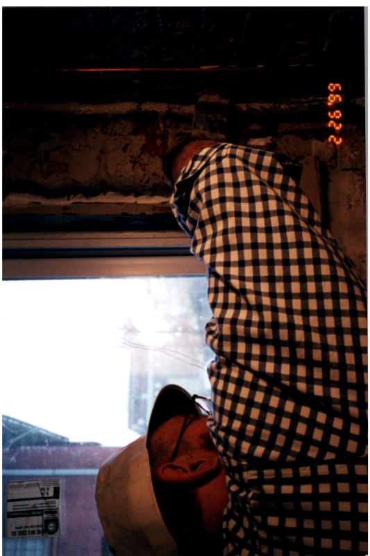 A man helps place windows