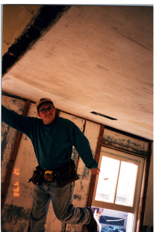 A man works on a ceiling