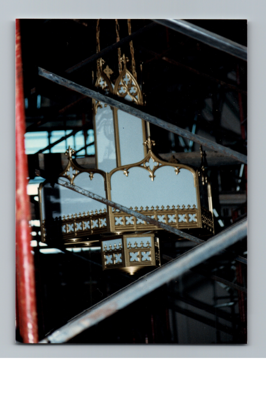 Light fixture seen through damaged roof