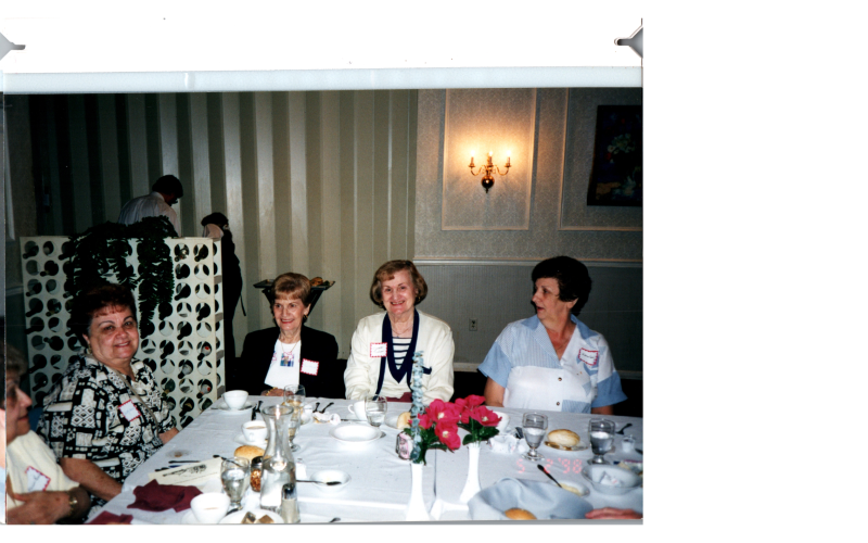 A group of older women eat together