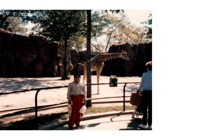 Woman smiles with a giraffe